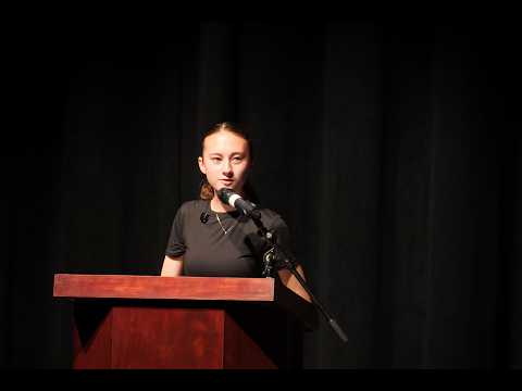 Kathryn Anderson speaking at a podium