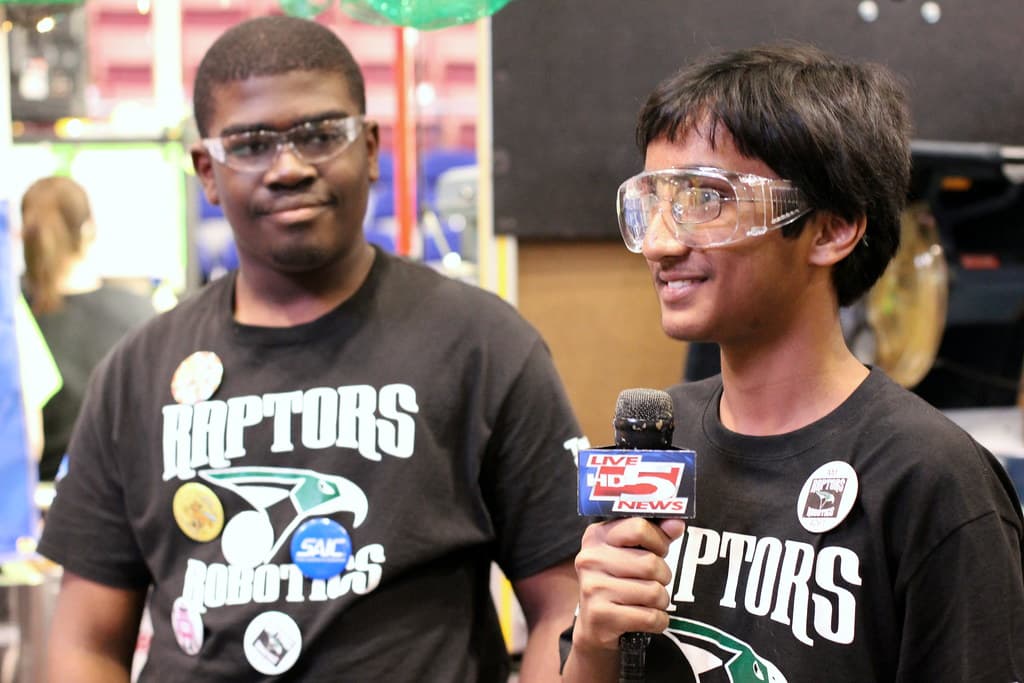 FIRST Robotics team working on a robot at a regional competition