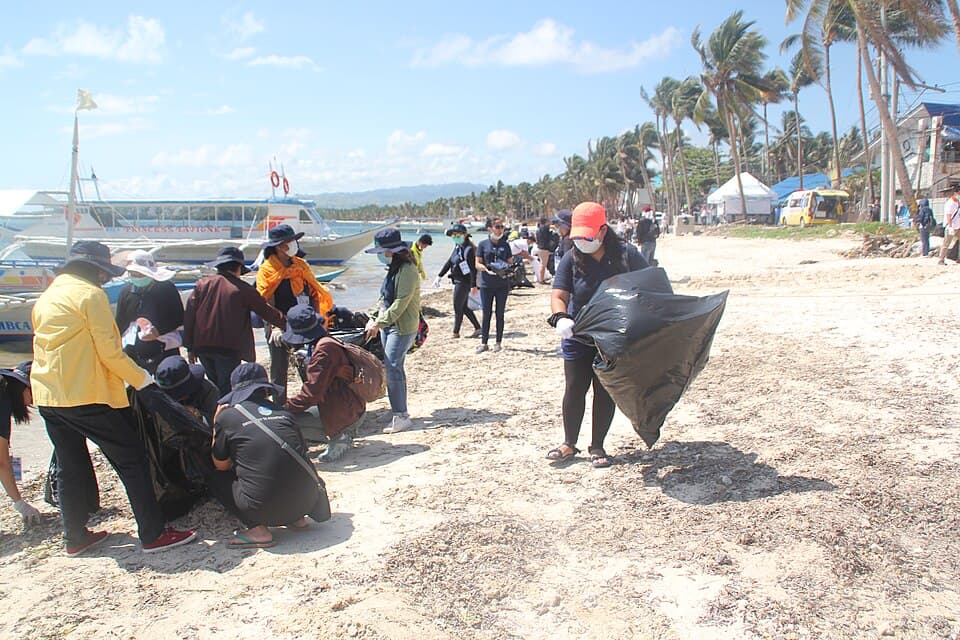 Volunteers collecting trash during a coastal cleanup
