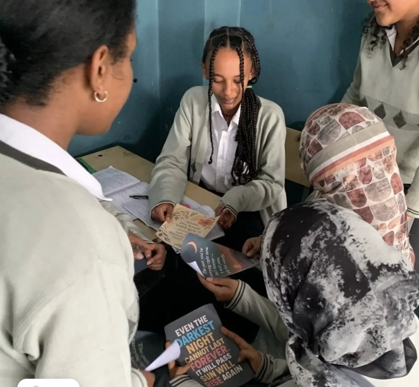 Students sharing 988 crisis lifeline bookmarks