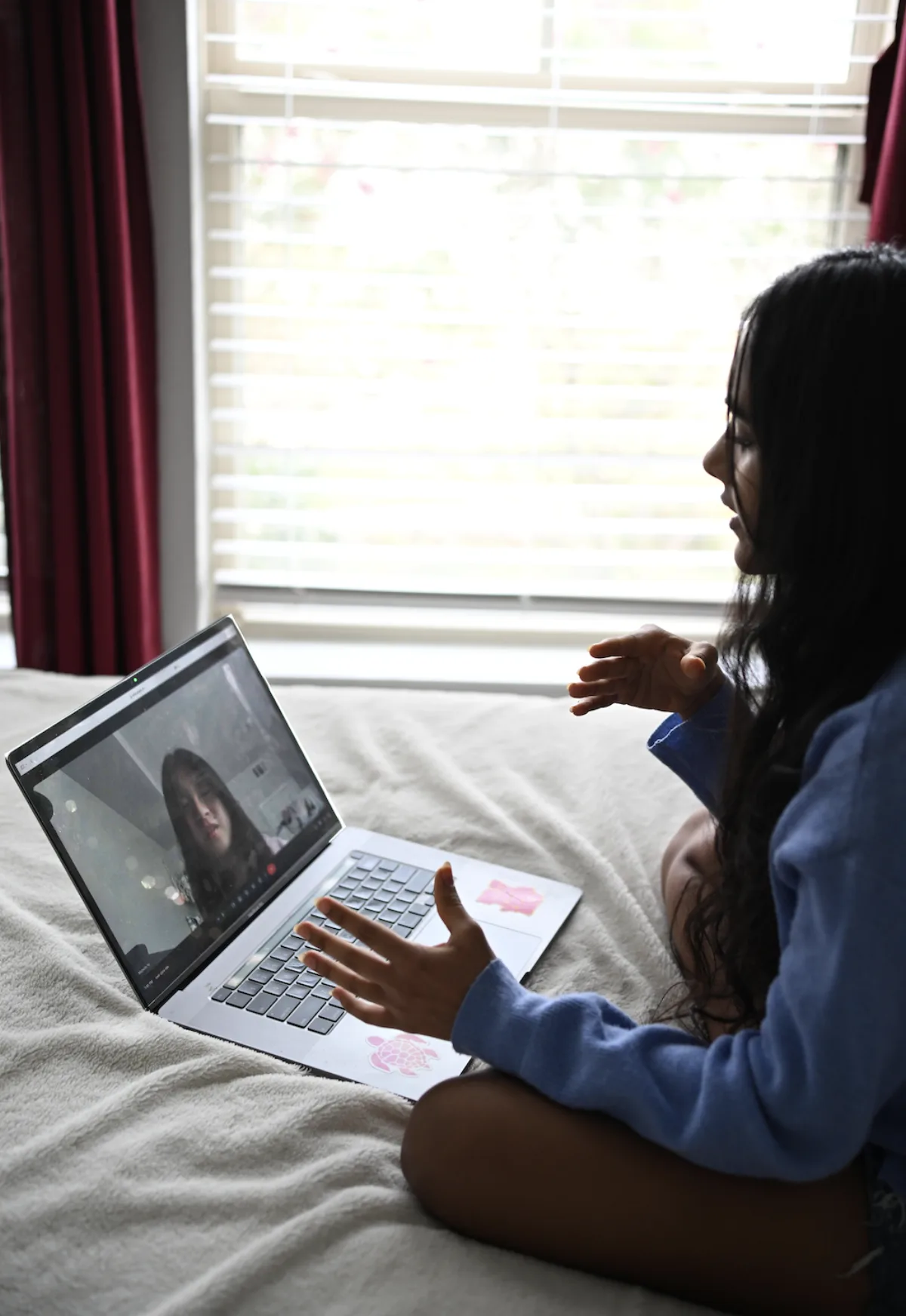 A Project EDSA leader speaking with a student during a virtual meeting