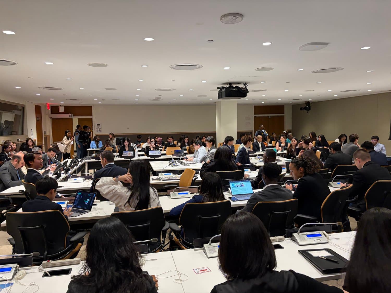 Young delegates working together at an international policy forum